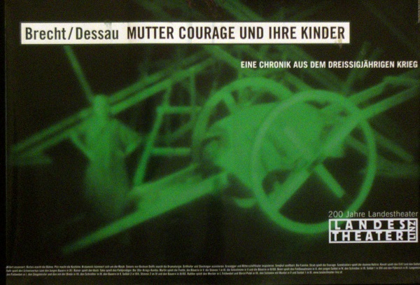 Poster with a green-black night vision photo of Mutter Courage and her wagon